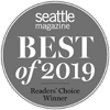 The image shows a circular badge with "Seattle Magazine Best of 2019 Readers' Choice Winner" written on it in white letters on a gray background.
